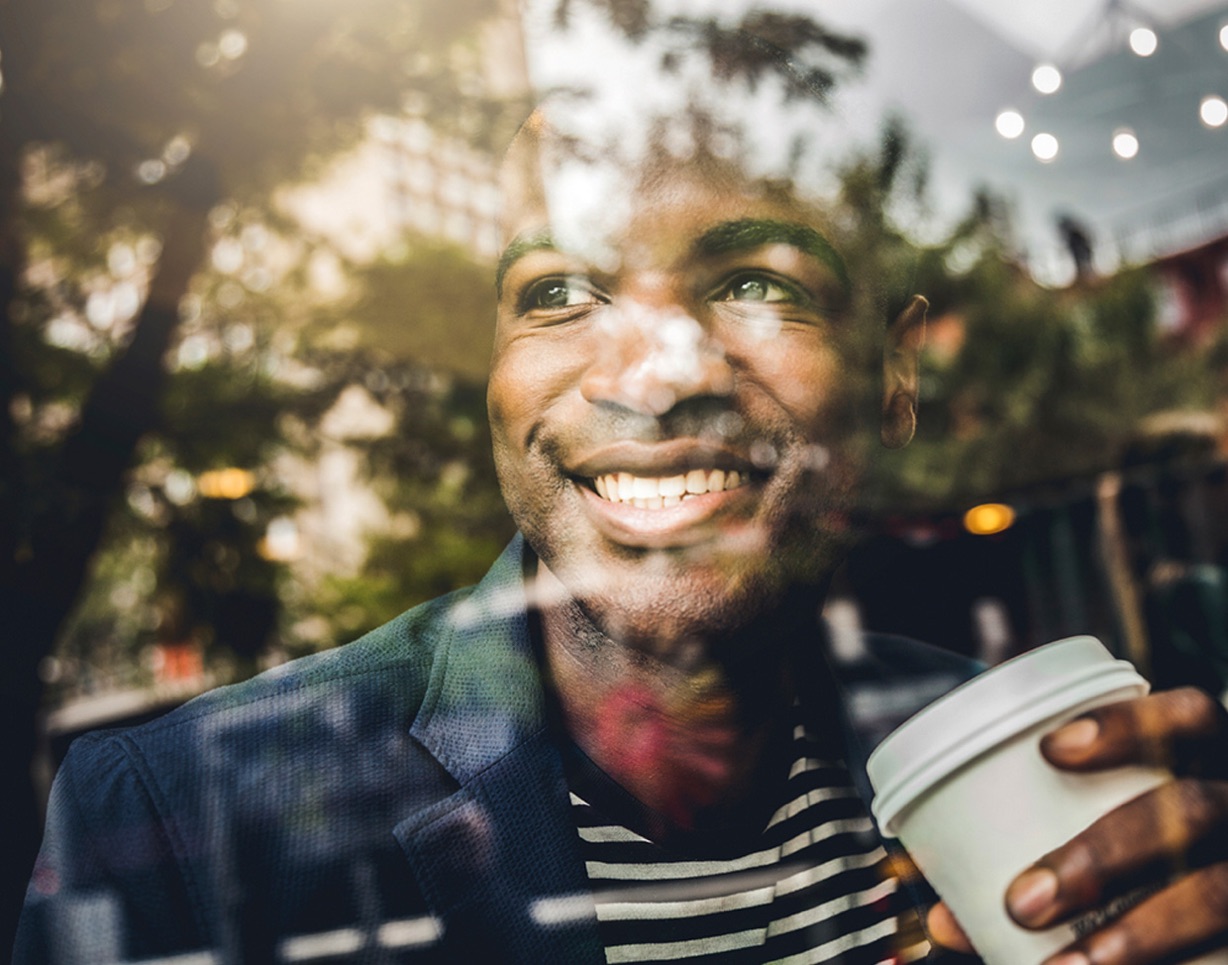 Man smiling through a window